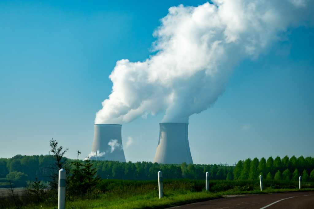 View on cooling towers of nuclear power plant thermal power station in which heat source is nuclear reactor, France, Europe, cheap energy source